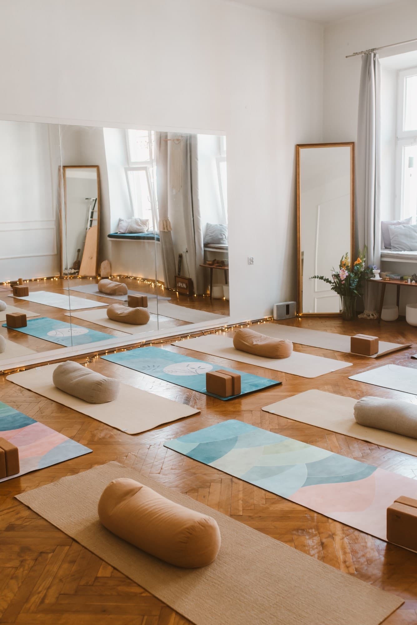 The room set for class: colourful mats, cork blocks and bolsters