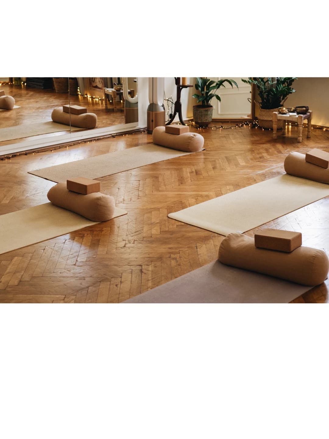 Mats, bolsters and blocks on the parquet floor of the studio