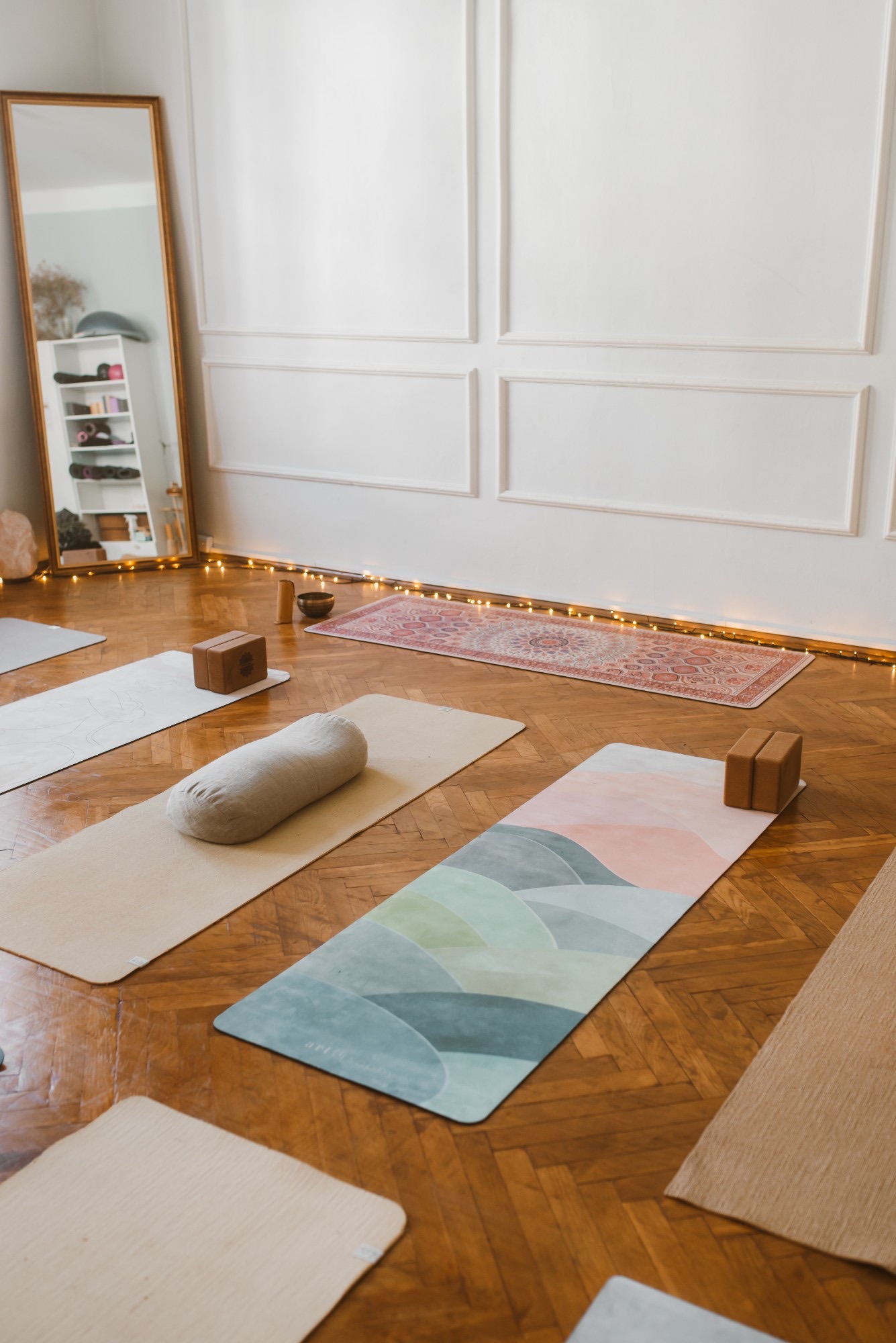 Mats, blocks, a linen bolster and a rug by the panelled wall